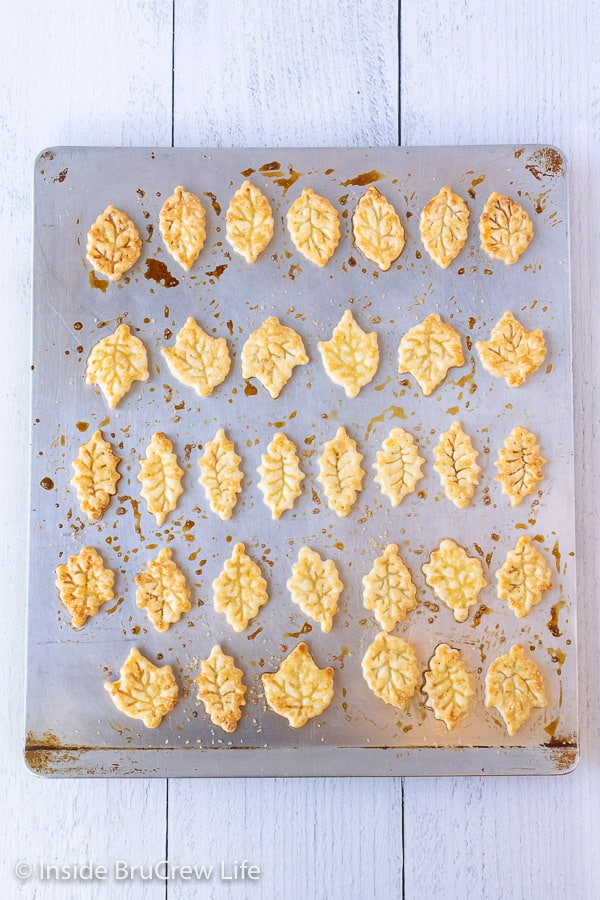 Overhead picture of a baking sheet with baked pie crust cookies on it