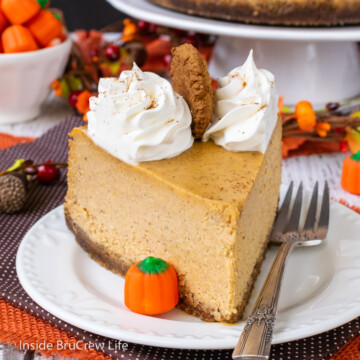A slice of pumpkin cheesecake on a white plate.