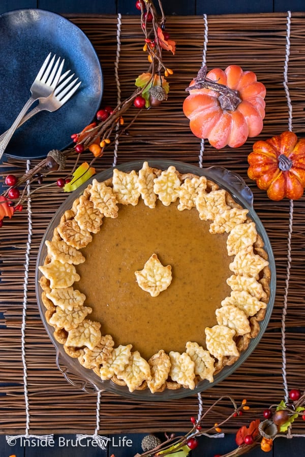 Overhead picture of a full traditional pumpkin pie decorated with pie crust cookies