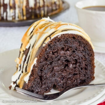 A white plate with a slice of mocha bundt cake topped with caramel, white chocolate, and sea salt.