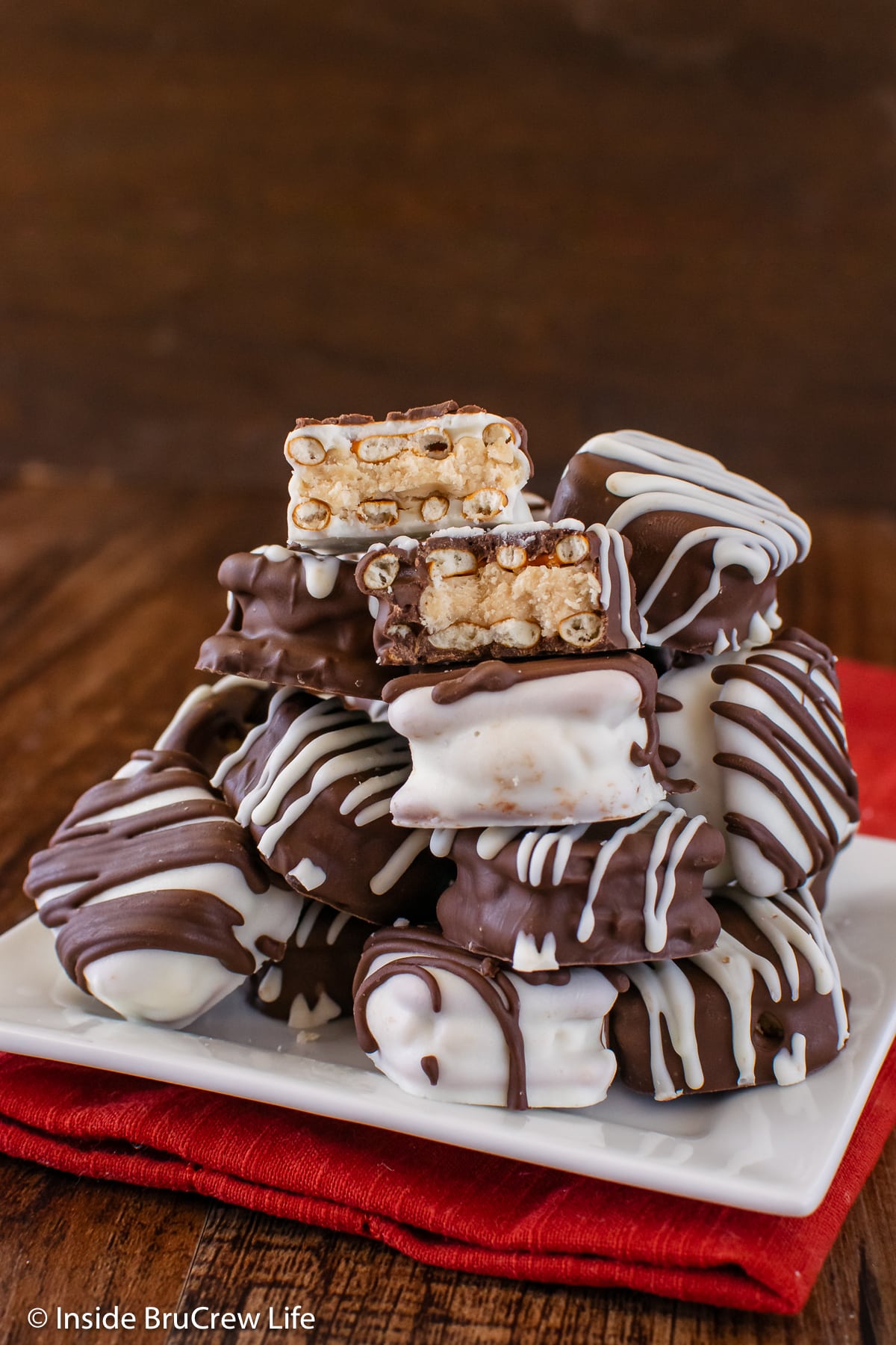 A white plate stacked with buckeye pretzel bites.