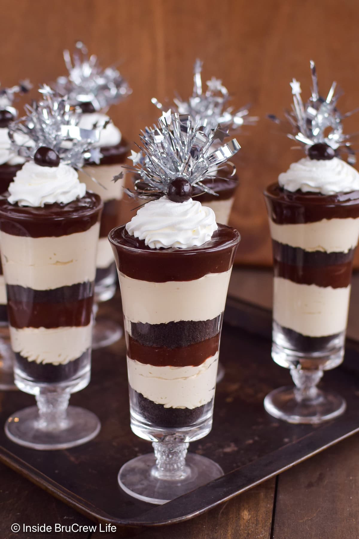 Clear cups with layers of coffee cheesecake and chocolate pudding.