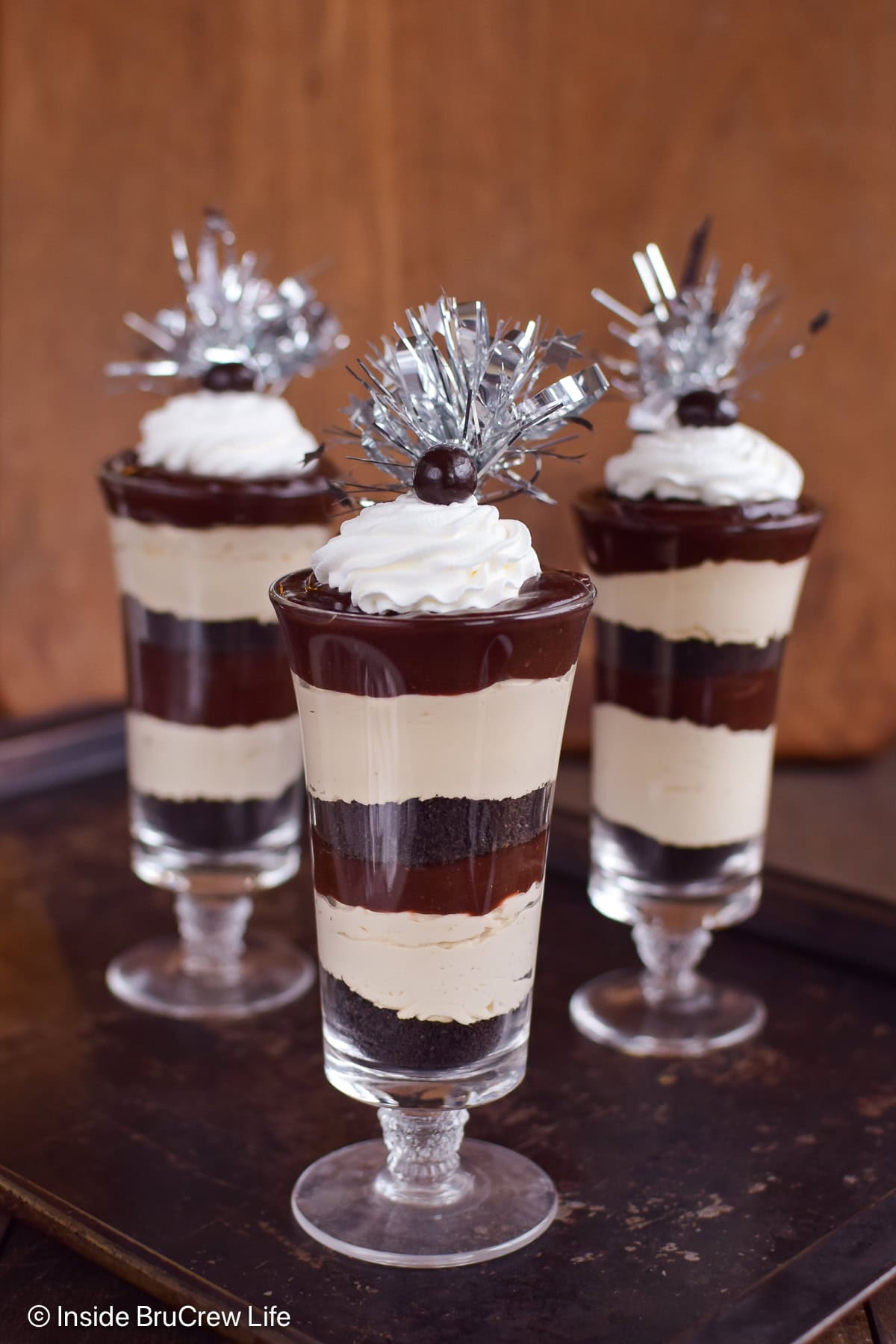 Three clear cups filled with coffee and chocolate layers.