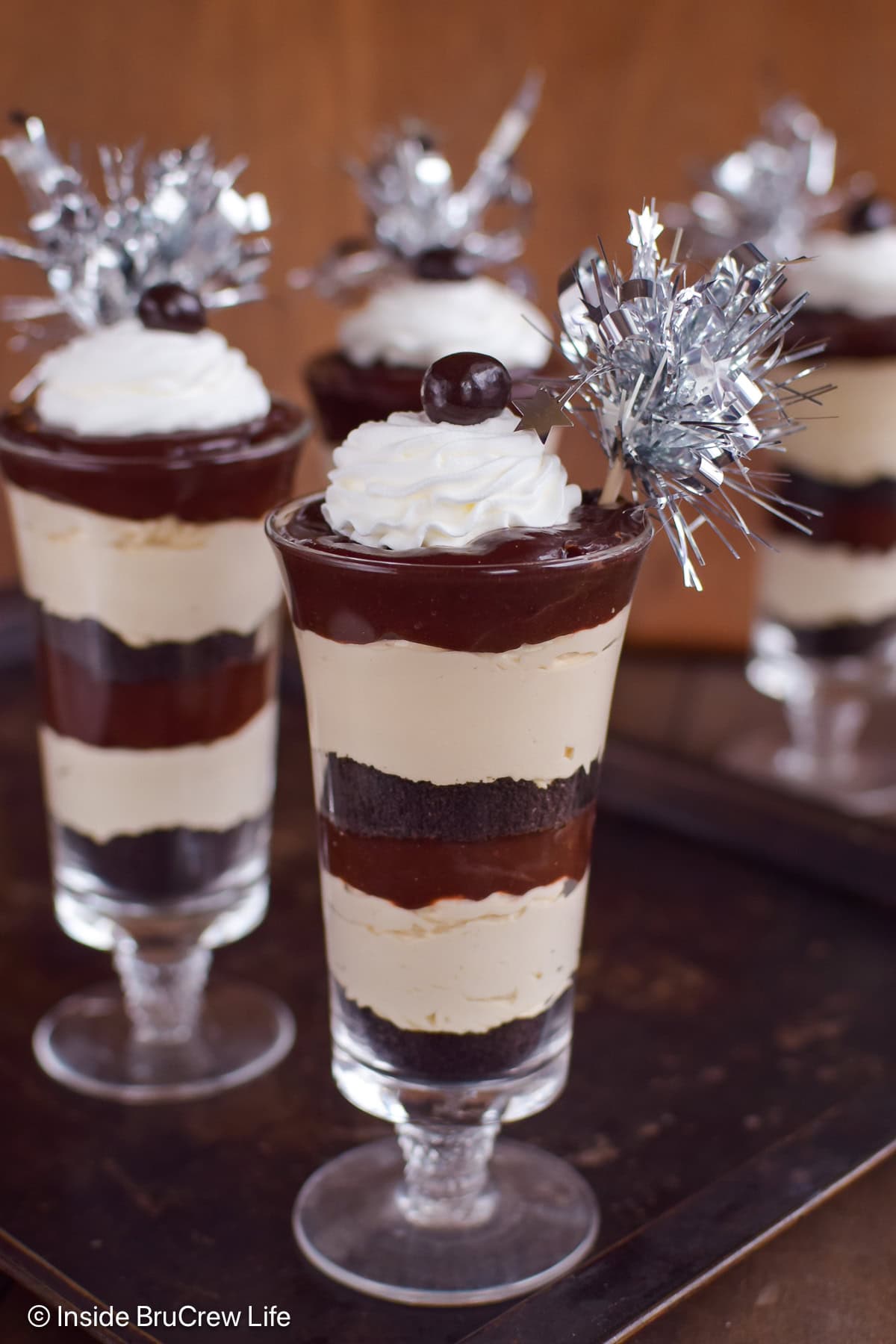 Parfait cups filled with Oreo cookies, coffee cheesecake, and chocolate pudding.