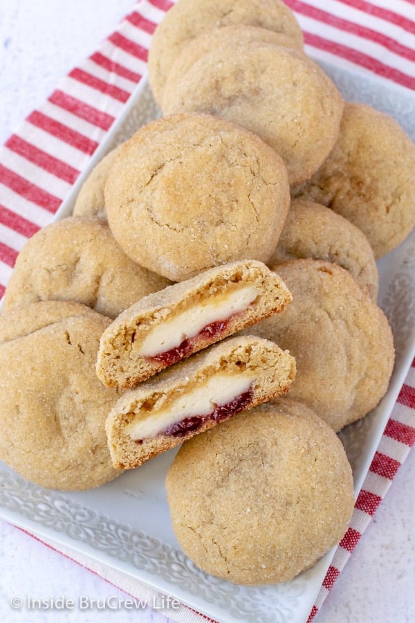 Strawberry Cheesecake Stuffed Cookies - soft sugar cookies stuffed with cheesecake and strawberry preserves are a fun cookie to make. Great recipe for dessert or parties. #cookies #cheesecake #stuffedcookies #sugarcookies #strawberry