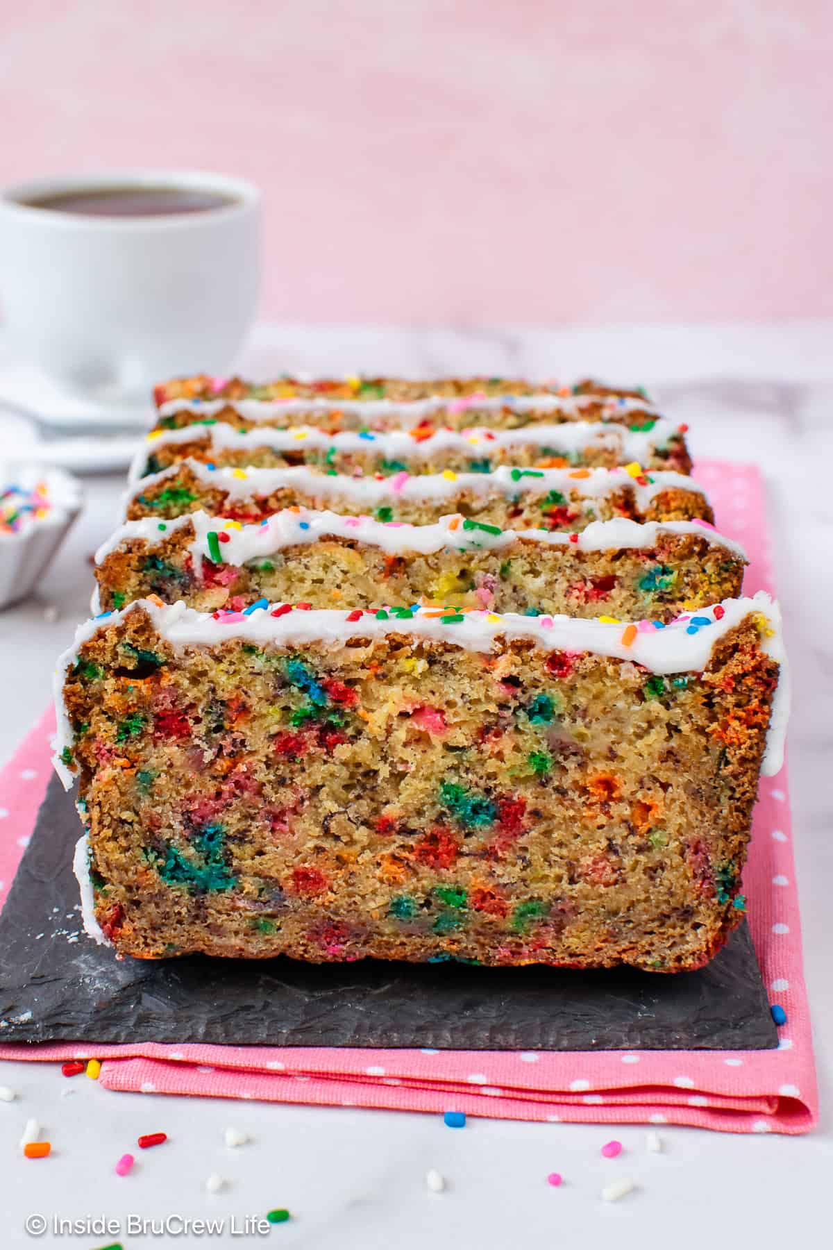 Slices of birthday cake banana bread on a tray.