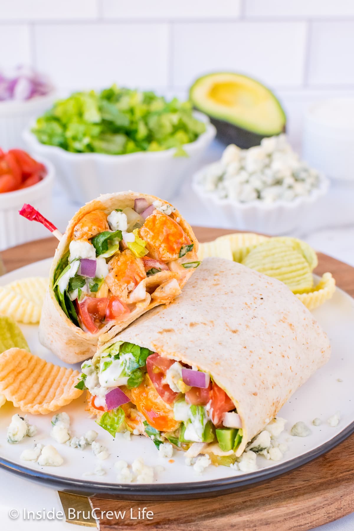 A chicken wrap cut in half and stacked together on a plate.