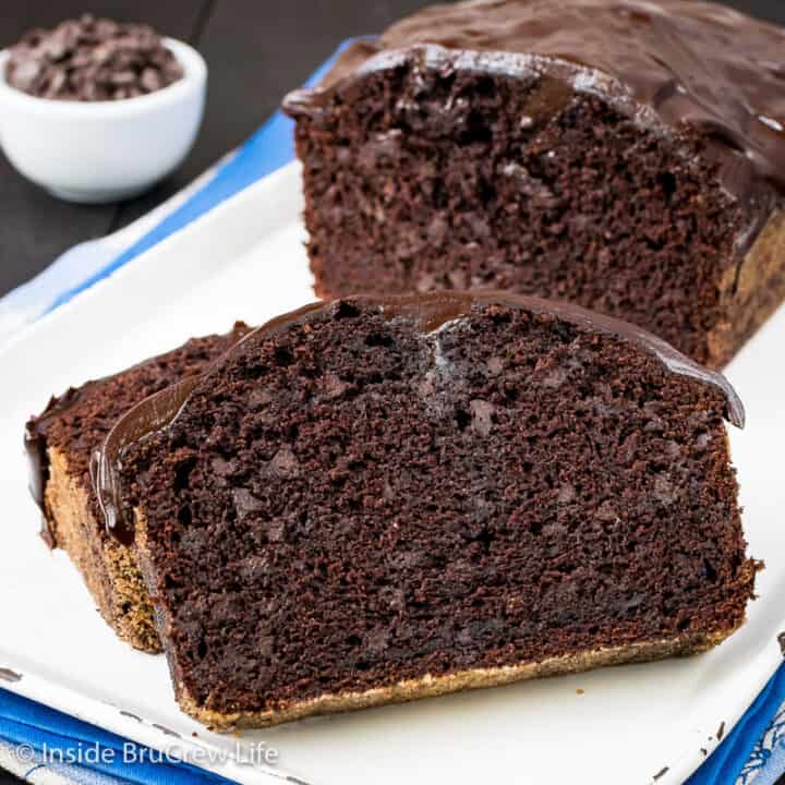 Two slices of chocolate banana bread on a white tray with