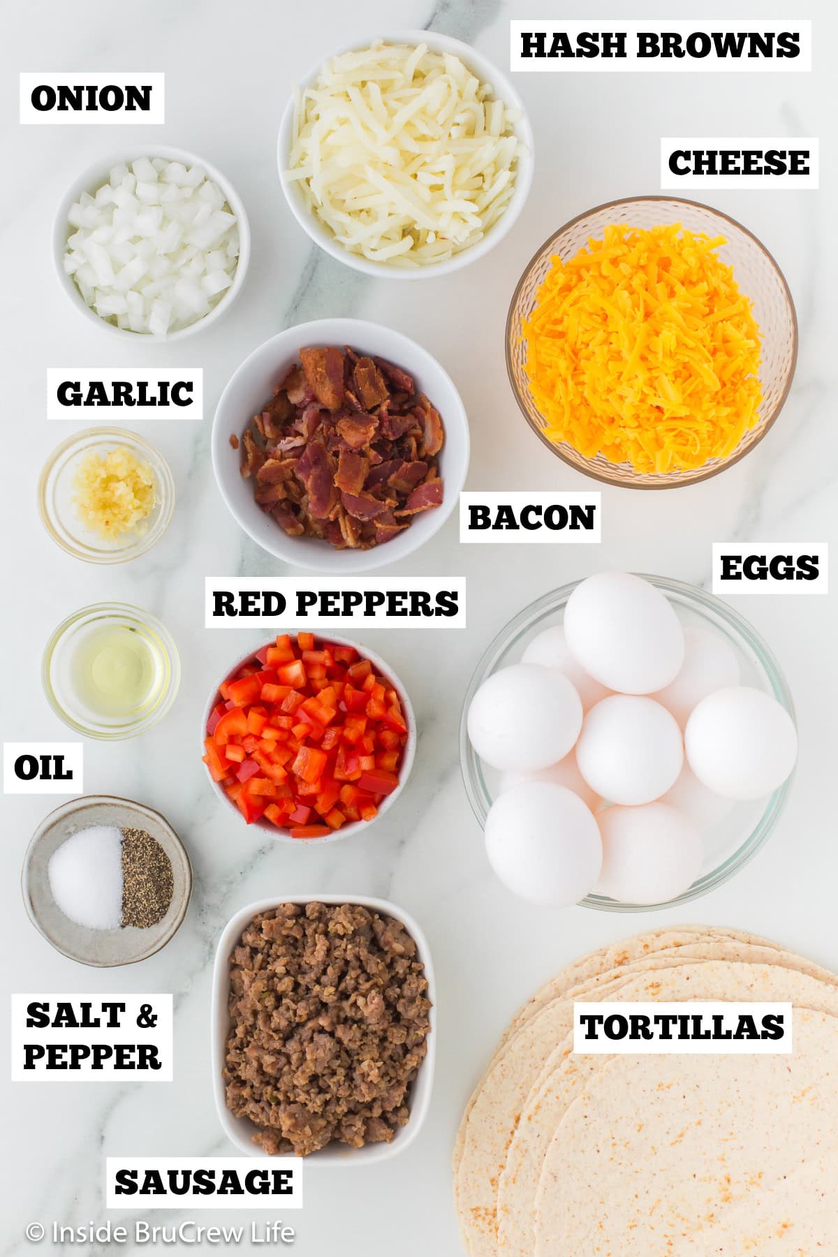 A white board with bowls of ingredients needed for egg burritos.