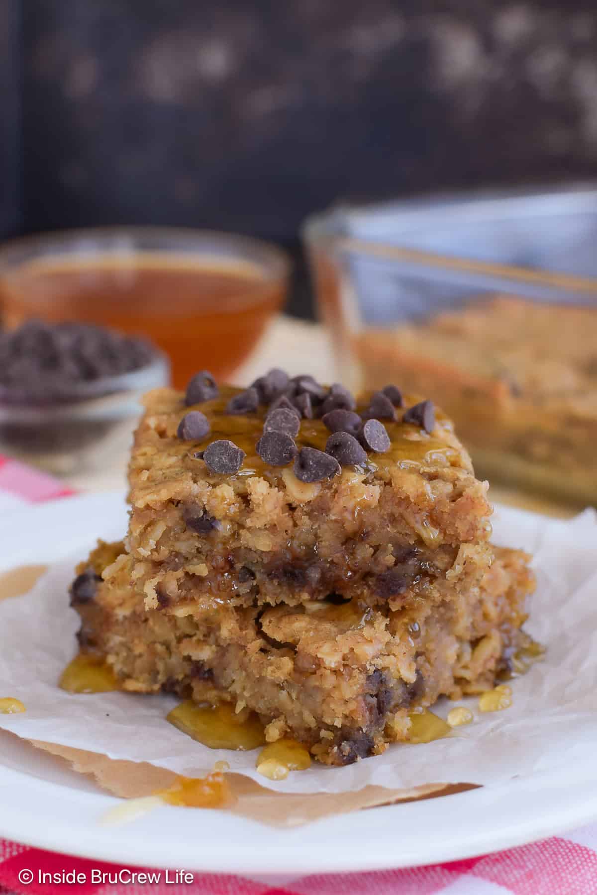 Two squares of peanut butter baked oatmeal stacked on a plate.