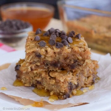 Two squares of peanut butter baked oatmeal stacked on a plate.