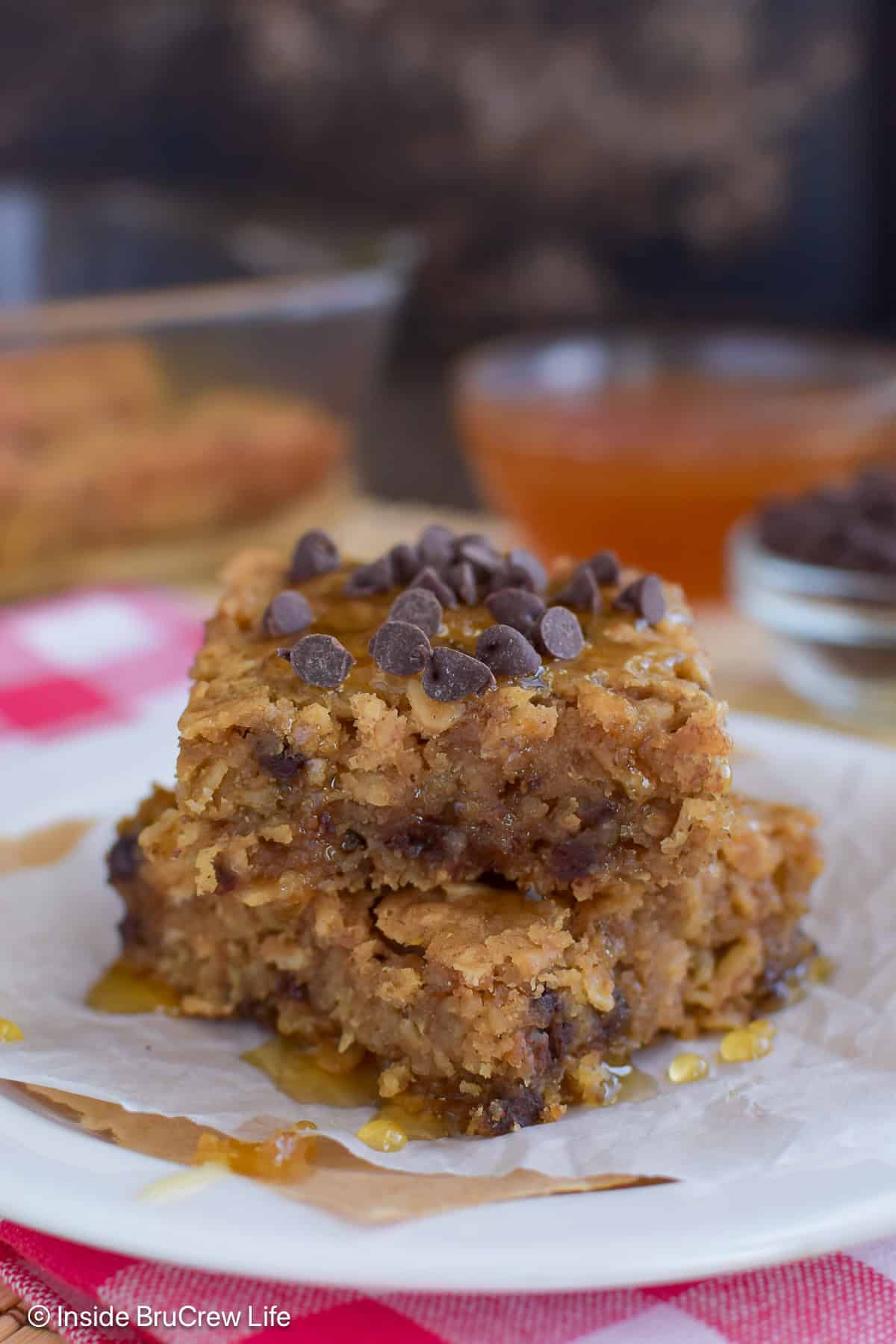 Two squares of chocolate chip peanut butter baked oats on a plate.