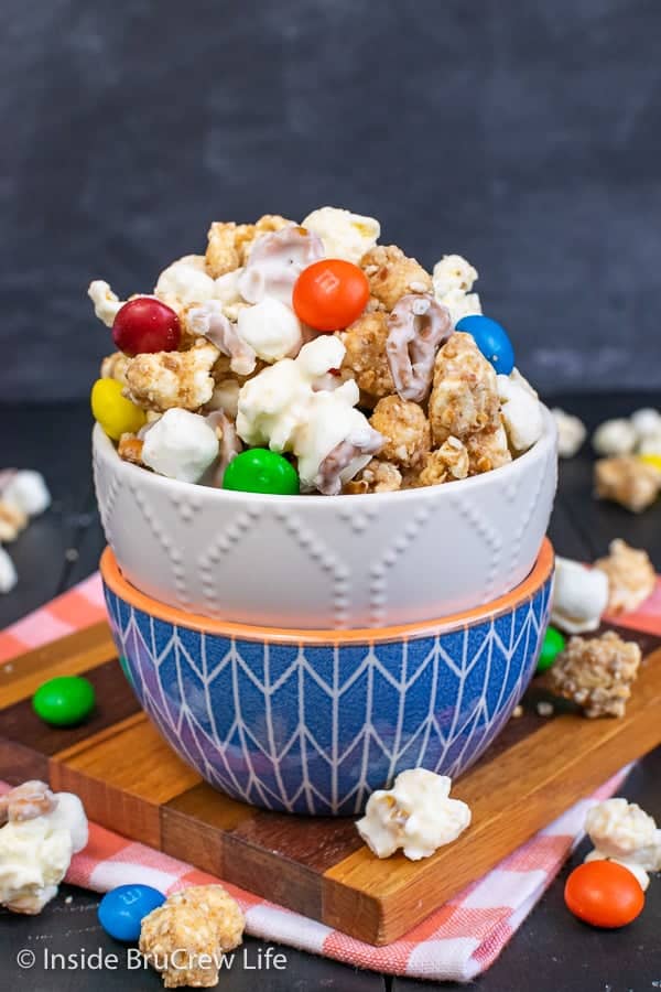 White Chocolate Peanut Butter Pretzel Popcorn - this fun white chocolate covered popcorn is loaded with candies and pretzels. Make this easy no bake recipe to munch on during movies or games. #popcorn #chocolatecoveredpopcorn #whitechocolate #peanutbutter #pretzel #gameday #snackmix #nobake