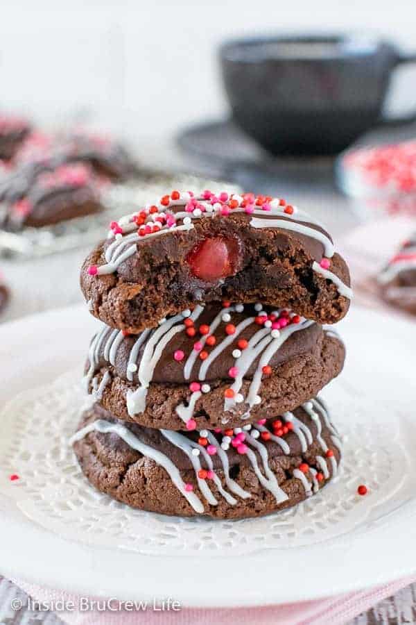A white plate with chocolate cookies with a hidden cherry center.