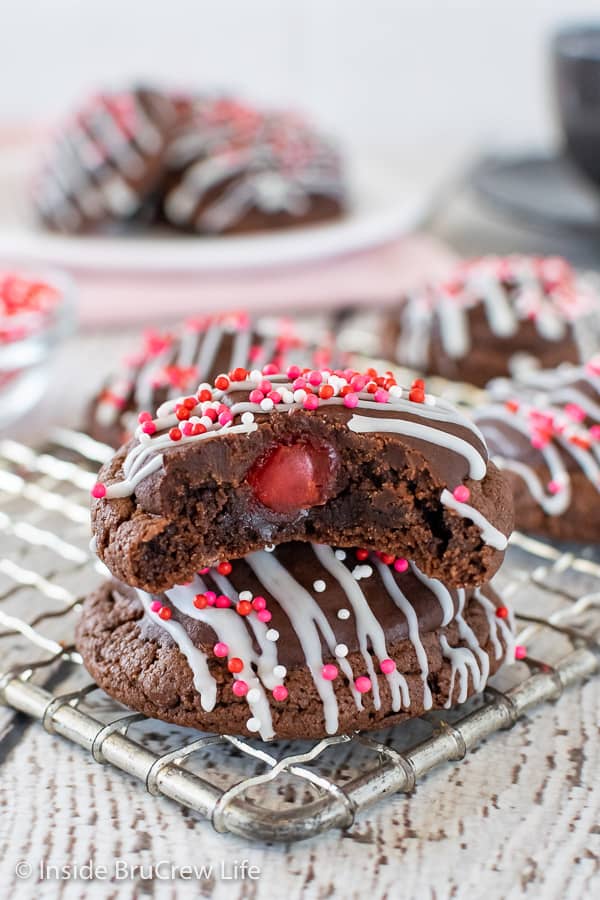2 chocolate cookies covered in chocolate with a cherry center.