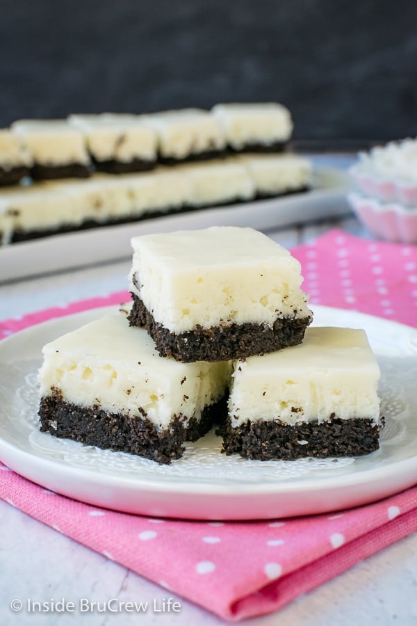 3 pieces of white coconut fudge with an oreo cookie base on a white plate.