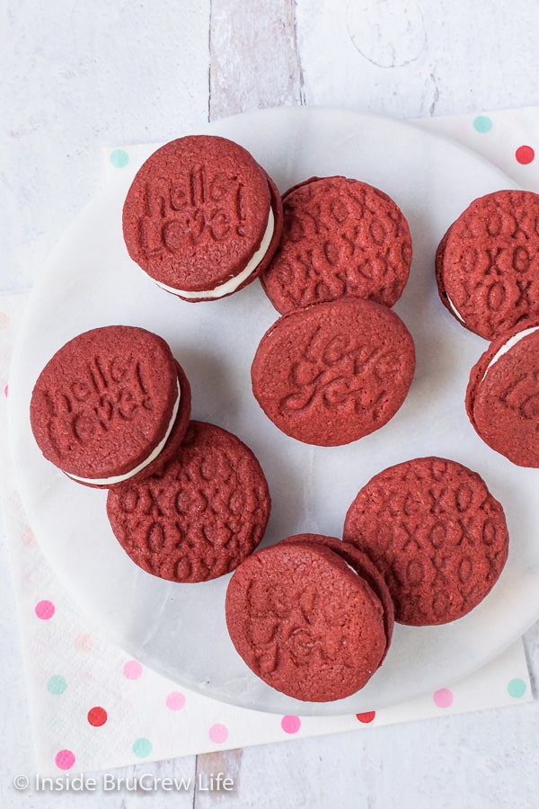 Copycat Red Velvet Oreos - a creamy frosting center in crunchy red velvet cookies makes them taste just like Oreos. Fun cookies to make for parties! #redvelvet #Oreos #copycat #sandwichcookies #valentinesday #creamfilledcookies