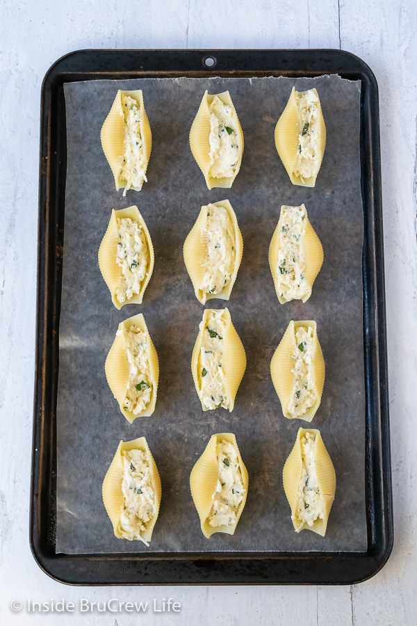 A sheet pan with stuffed shells on to freeze for later.