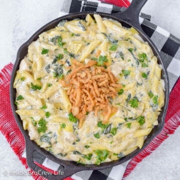 Overhead picture of a black skillet full of creamy chicken pasta