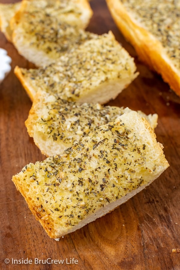 Easy Garlic Herb Bread - this easy garlic bread can be made right before dinner or frozen for later. The garlic butter makes this French bread taste so good.