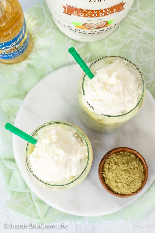 Overhead pictures of two iced green tea lattes topped with whipped cream.