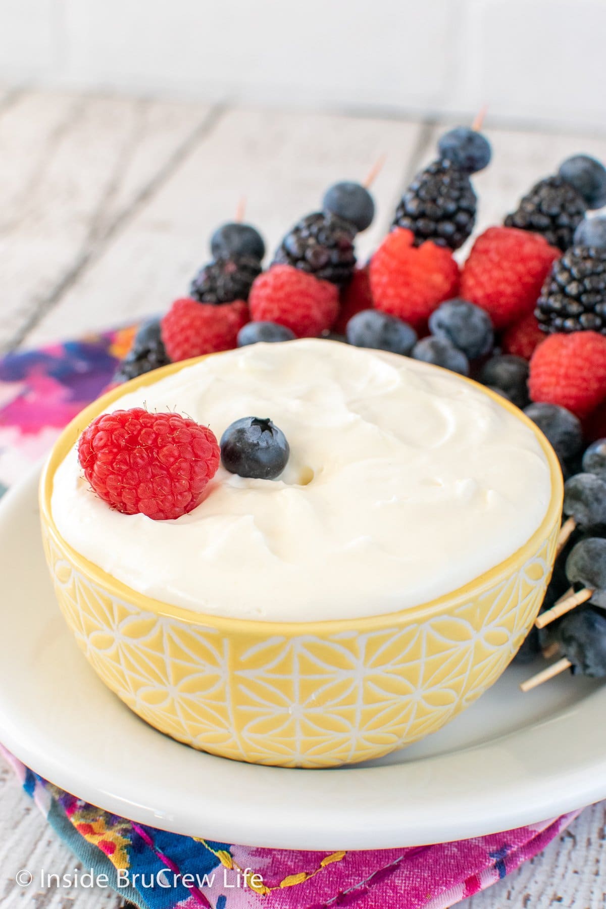 A bowl of lemon dip on a white plate.