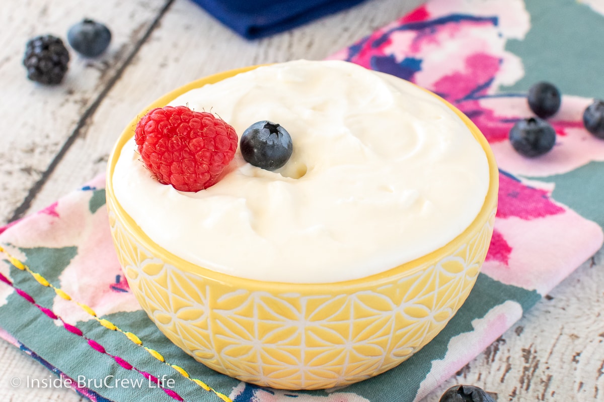 A yellow bowl filled with easy fruit dip.