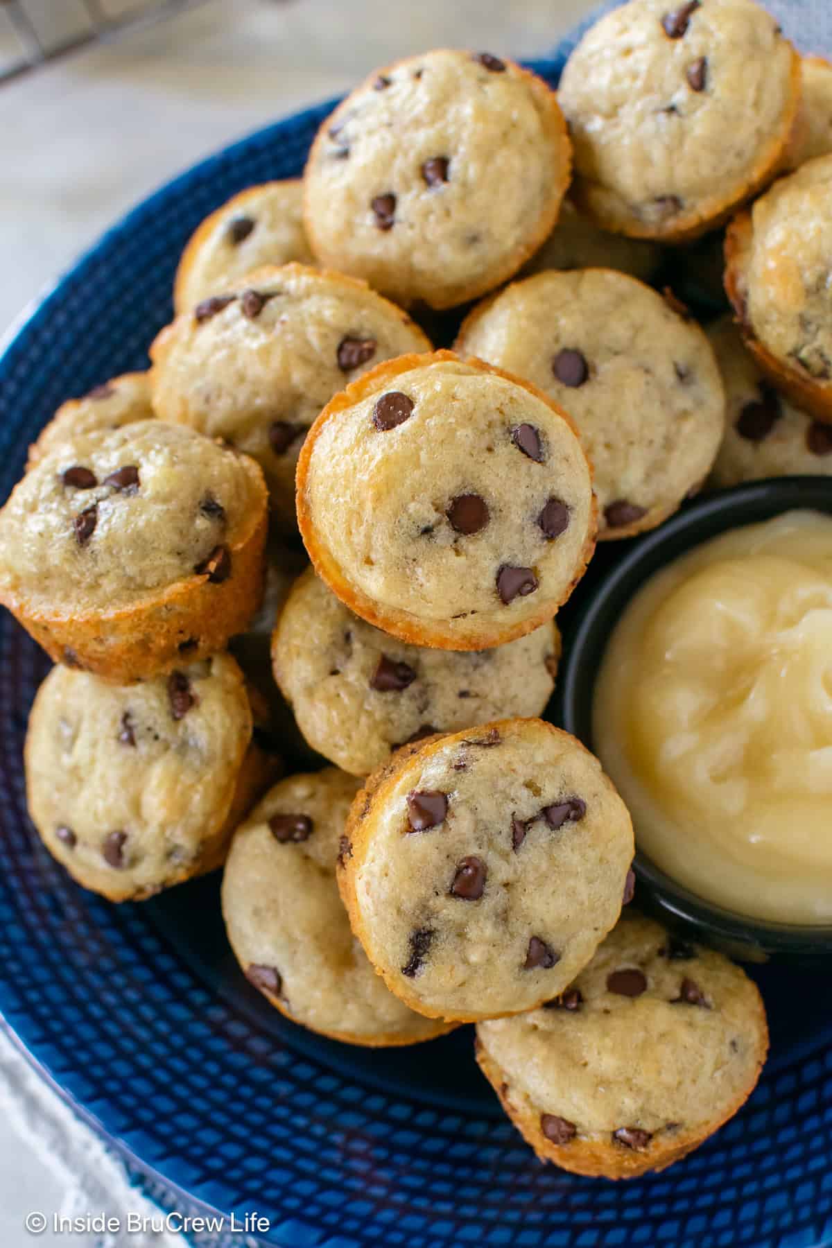 A stack of chocolate chip pancake bites on a blue plate.