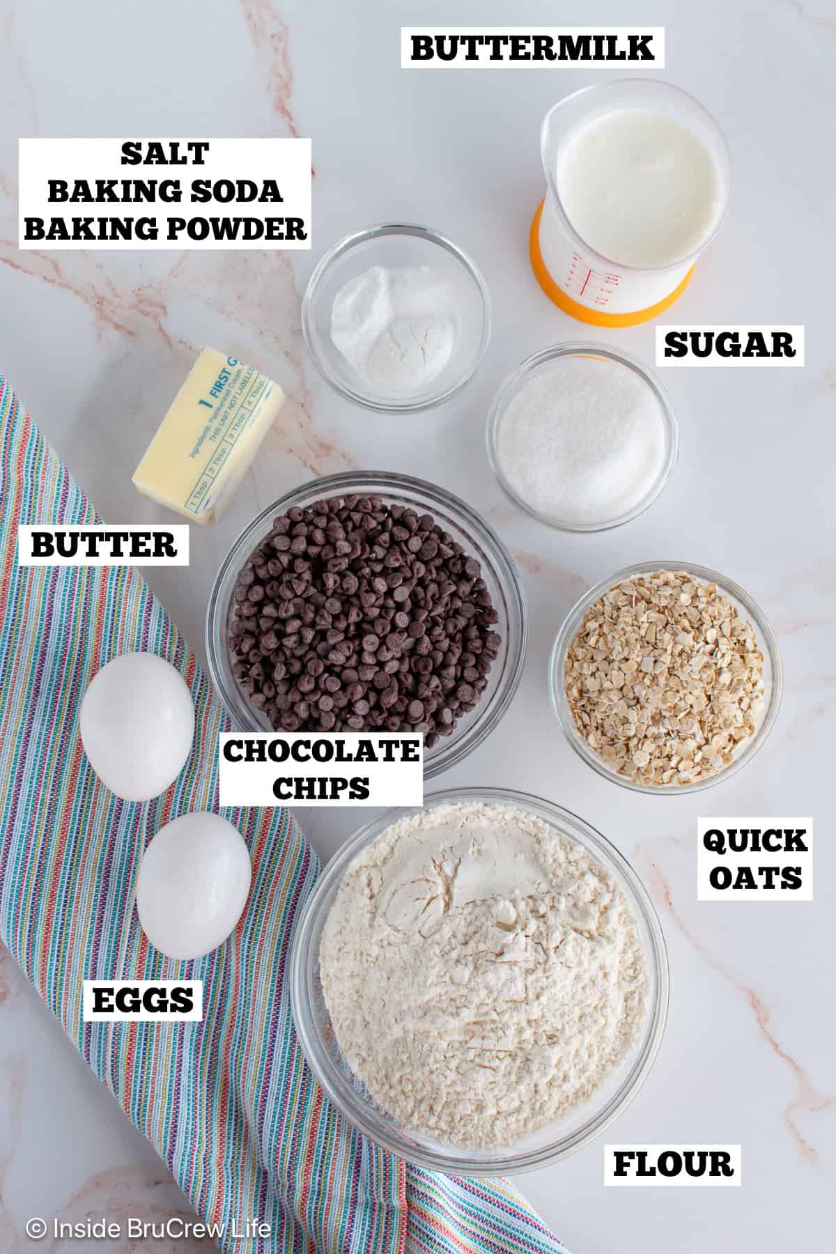 A white board with bowls of ingredients needed to make pancake bites.