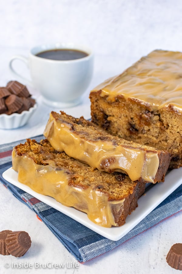 Two slices of peanut butter cup banana bread falling forward on a white plate