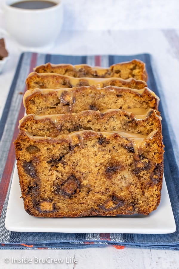 Slices of peanut butter cup banana bread on a white plate with a blue towel under it