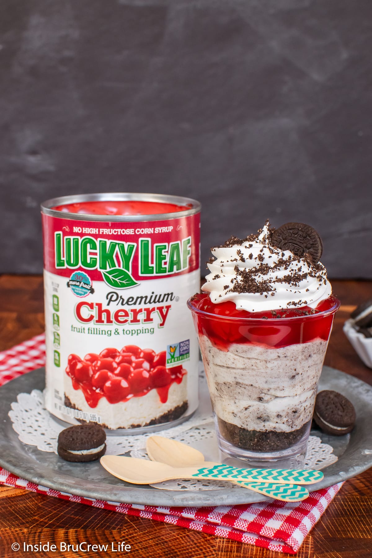 A cheesecake parfait sitting beside a can of pie filling.