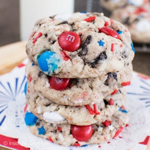 4 fireworks cookies with sprinkles and M&M's stacked on top of each other