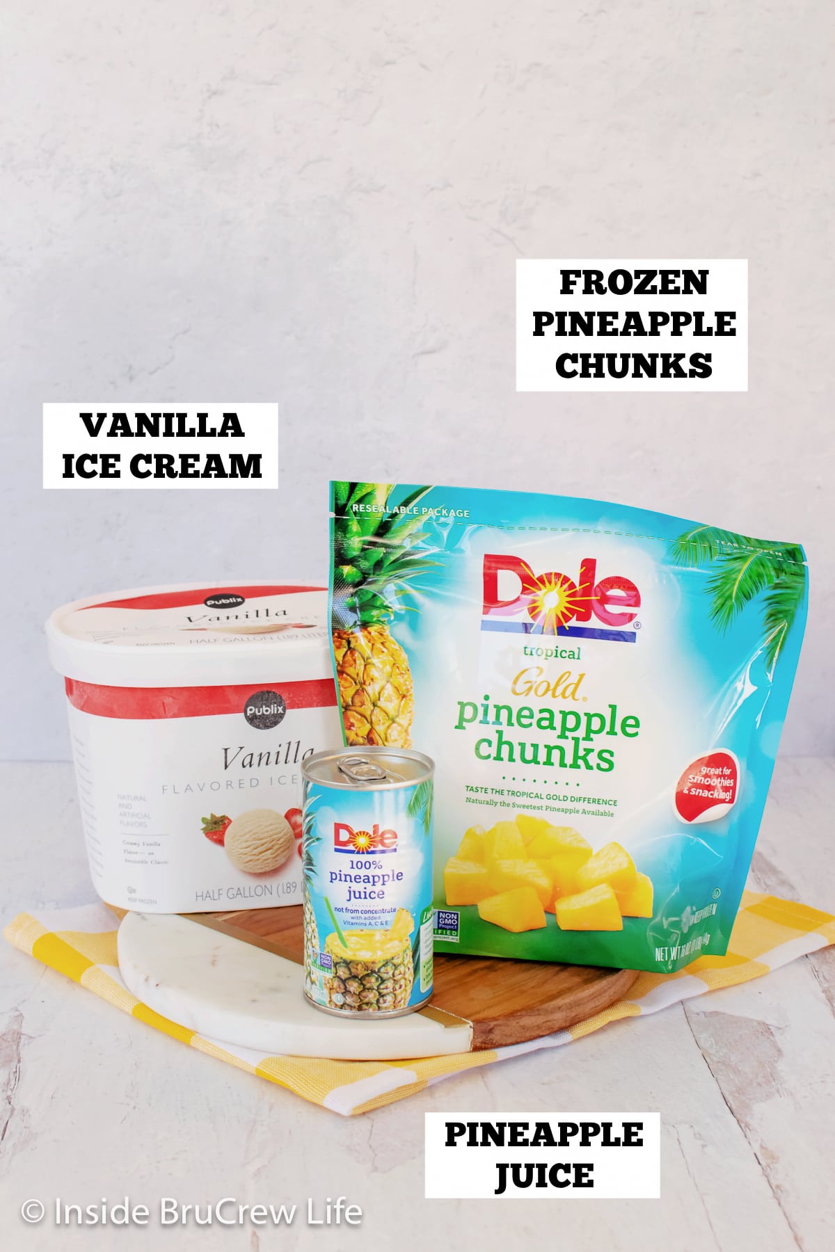 A picture of vanilla ice cream, pineapple juice, and frozen pineapple.