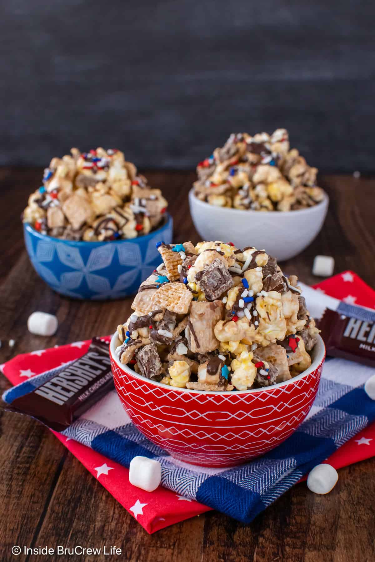 Three bowls filled to the top with s'mores popcorn mix.