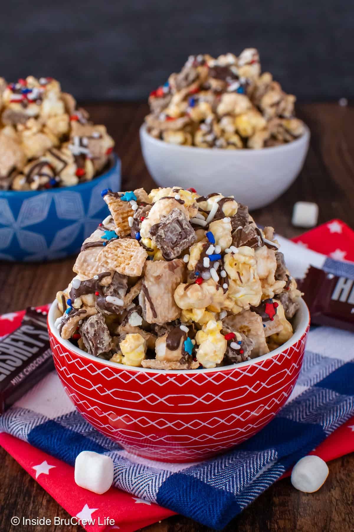 Three bowls filled to the top with s'mores popcorn mix.