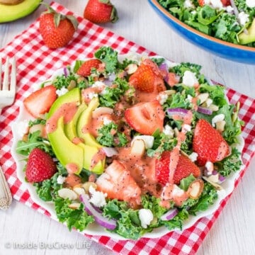 Strawberry Avocado Kale Salad - a big bowl of kale topped with strawberries, avocados, cheese, and nuts make a great healthy dinner. Easy recipe to make for spring or summer.