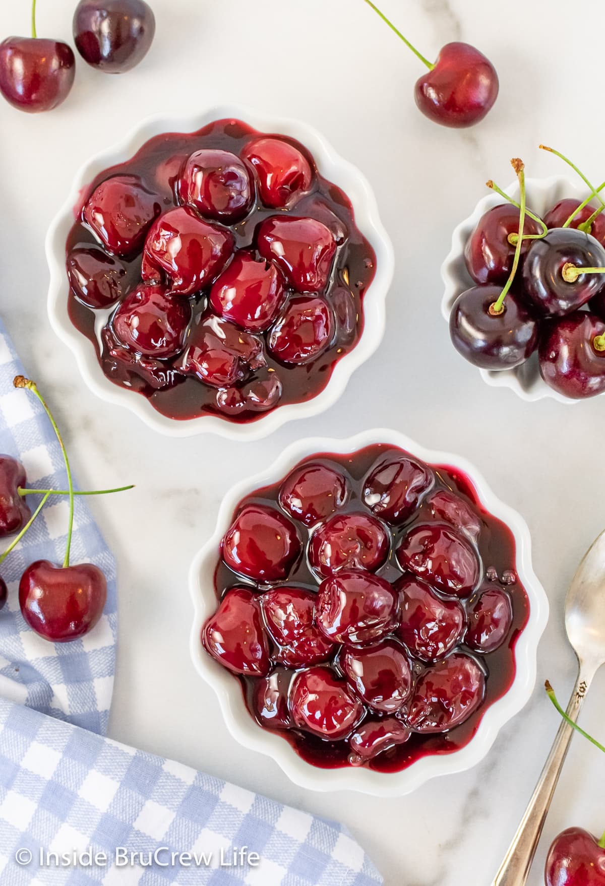 Two white bowls filled with cherry filling.