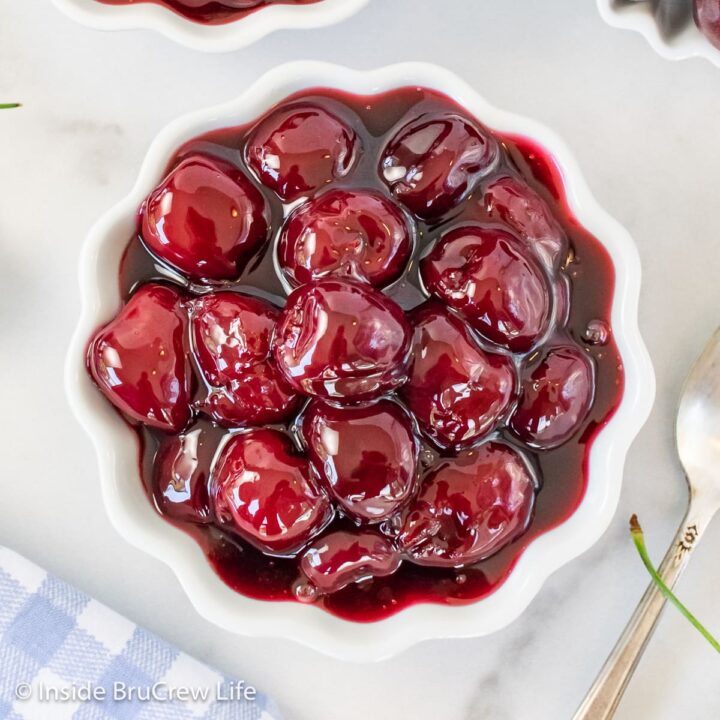 A white bowl with cherry pie filling in it.