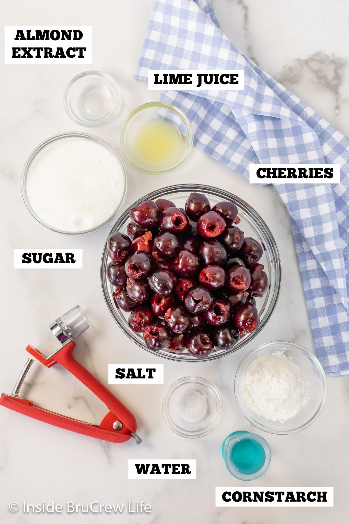 Ingredients needed to make a homemade pie filling with fresh cherries.
