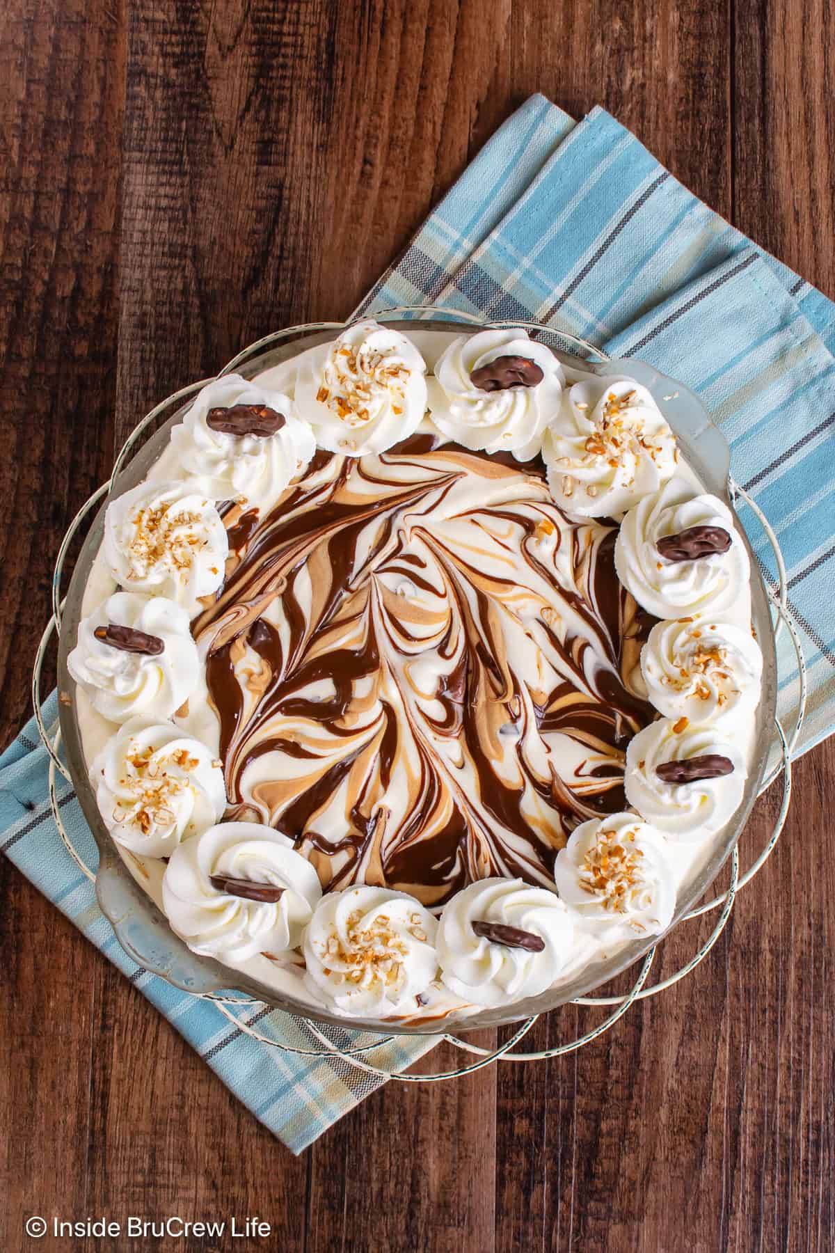 An overhead picture of a peanut butter fudge swirled ice cream pie.