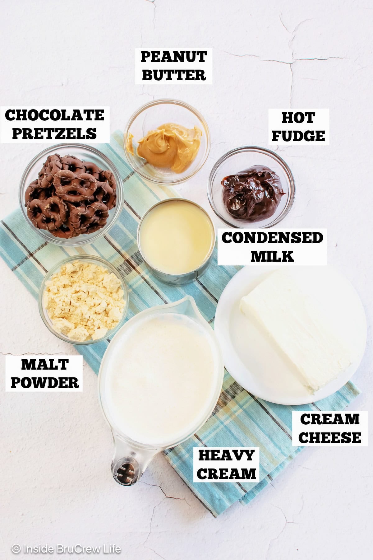 Ingredients for a malt ice cream pie with fudge, peanut butter, and pretzels.