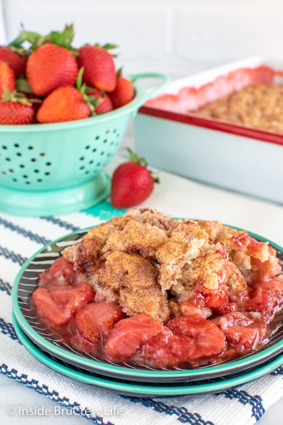 A serving of strawberries and biscuits on a plate.