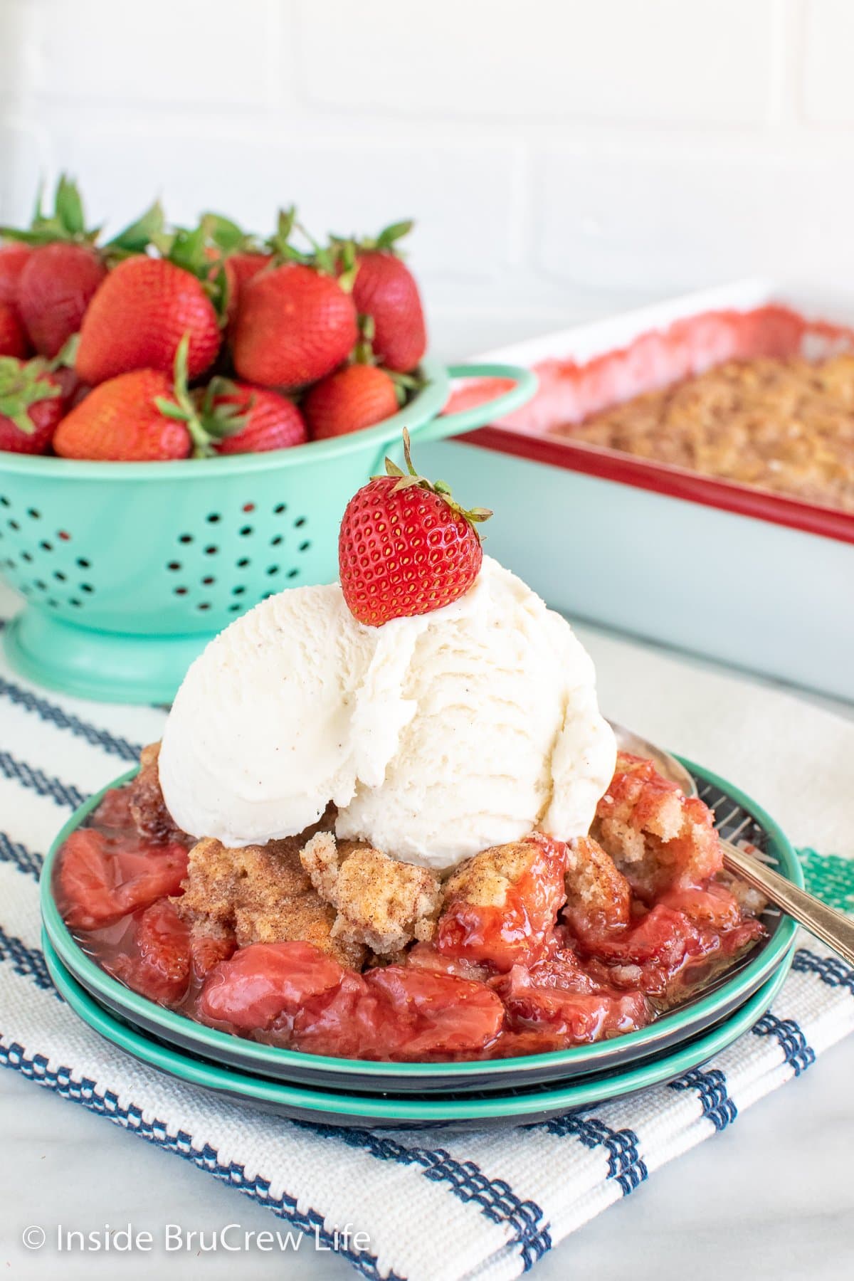 A plate with strawberry and biscuits with ice cream.