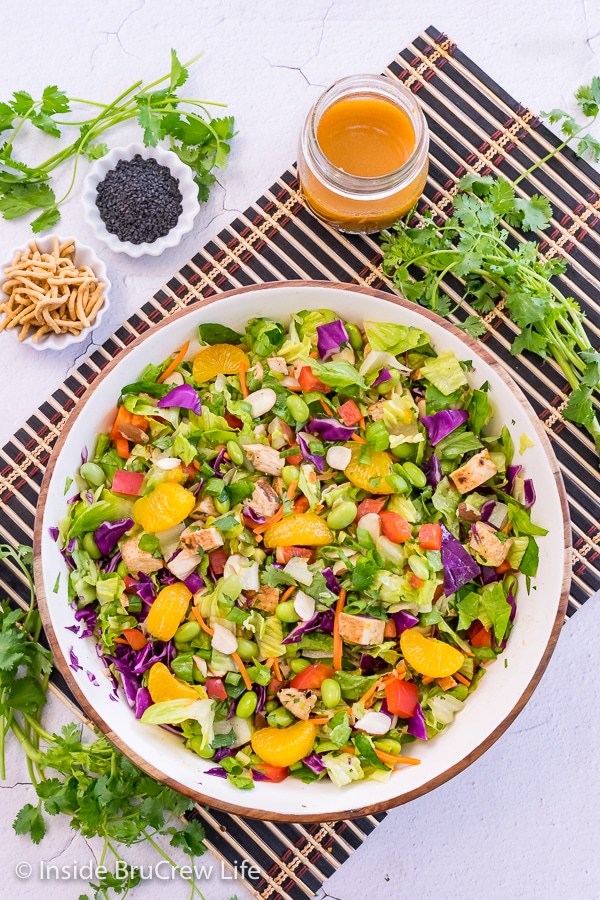 A salad bowl filled with a tossed asian chicken salad