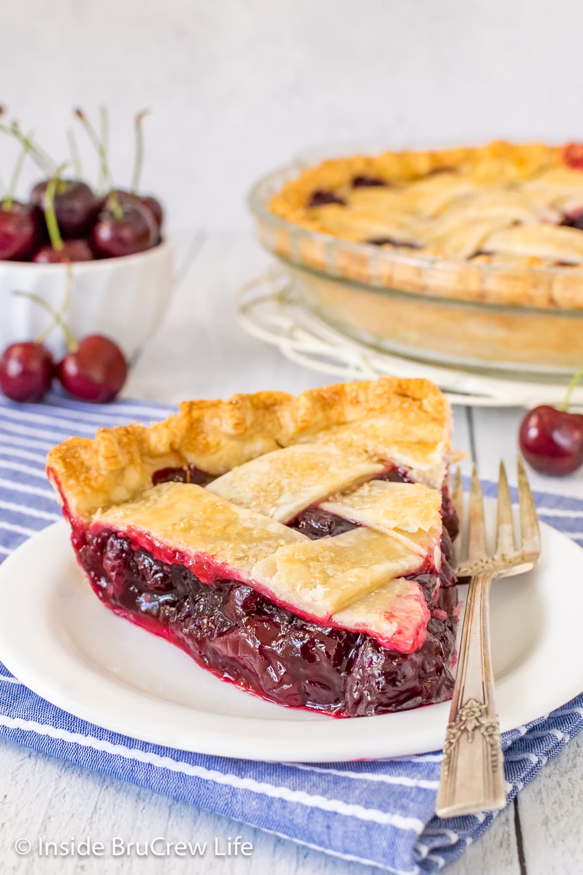 A slice of fruit pie on a white plate.