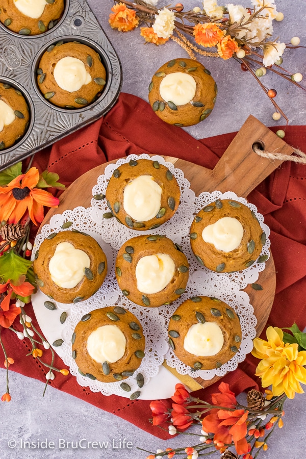 Overhead picture of pumpkin cream cheese muffins on a wood tray.