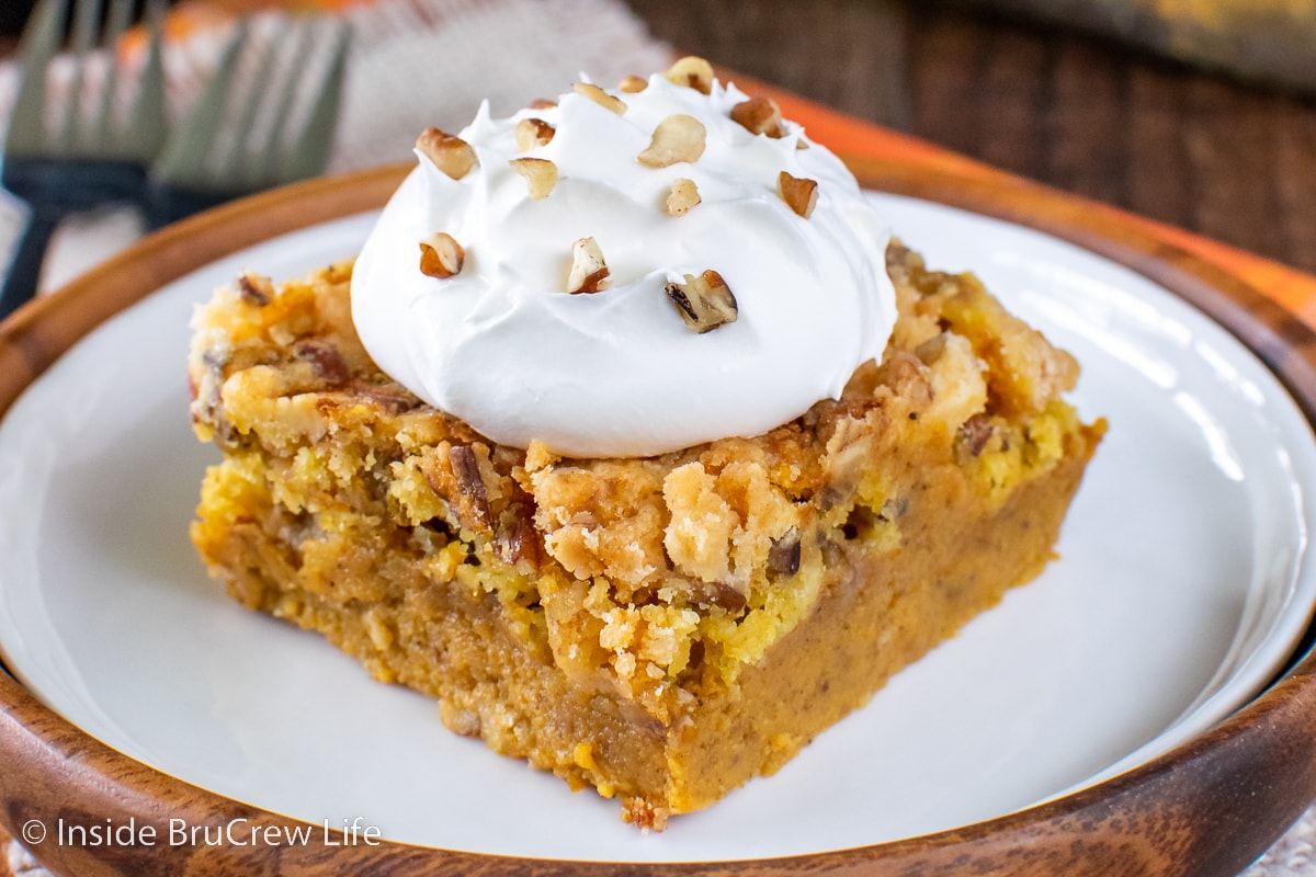 A white plate with a square of pumpkin cobbler on it.