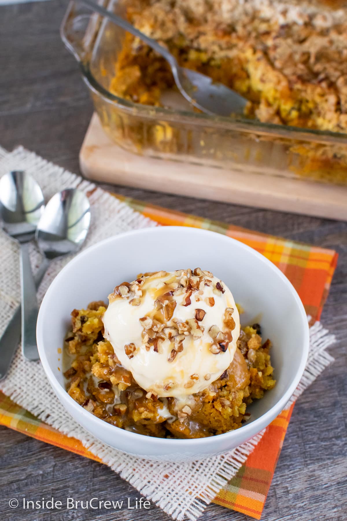 A white bowl filled with pumpkin dump cake.