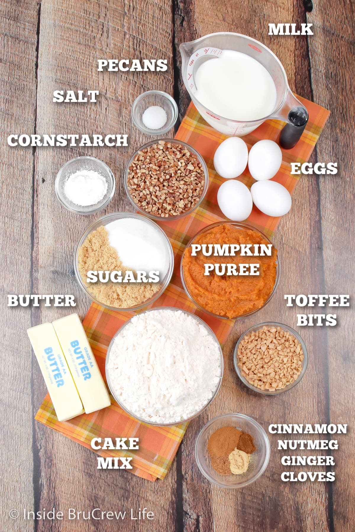 A board with bowls of ingredients needed to make a pumpkin dessert.